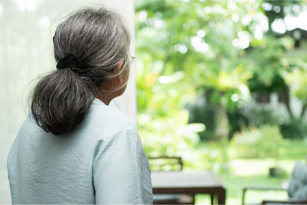 woman looking out at greenery