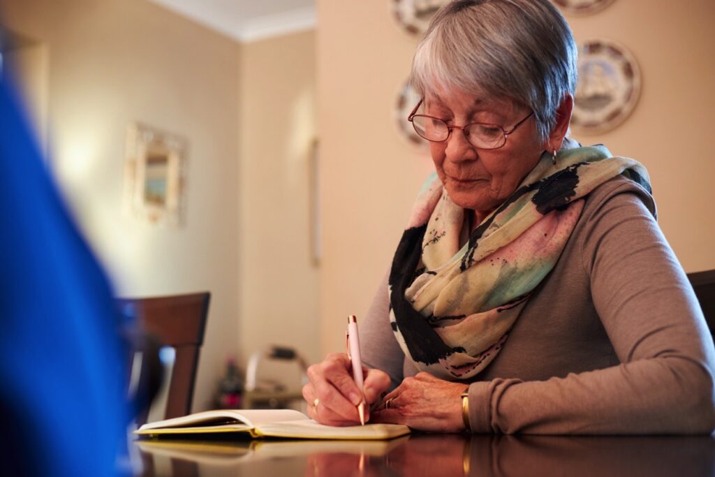 woman writing in book