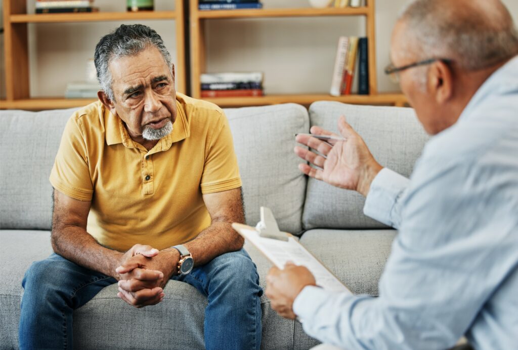 professional speaking to man on couch