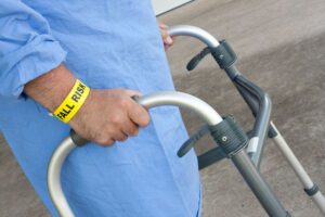 close-up of patient with fall risk wrist band using walker