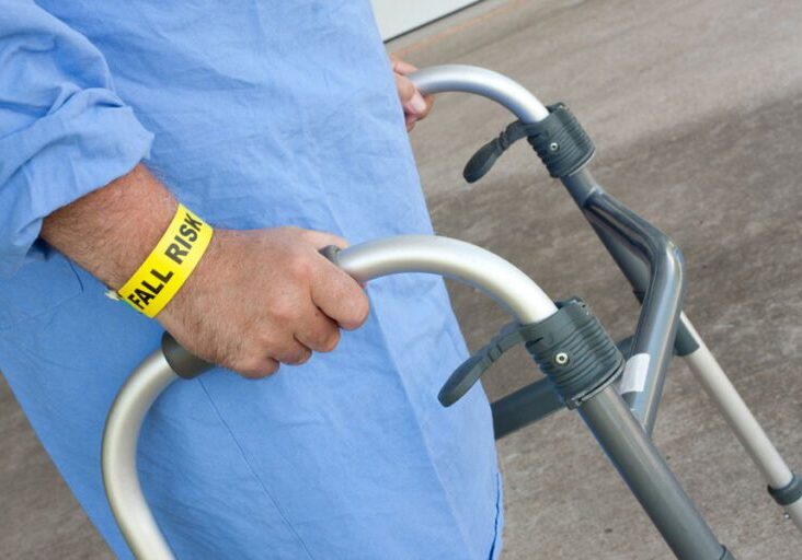 close-up of patient with fall risk wrist band using walker